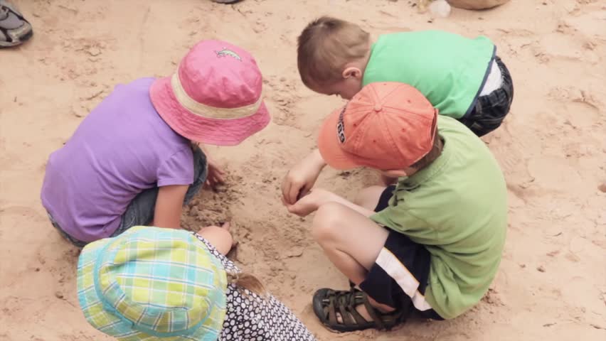 A group of kids playing in the desert sand