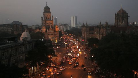 Nighttime aerial view of pedestrian and automobile traffic over central Mumbai Heritage buildings and CST Railway station, Mumbai, India 