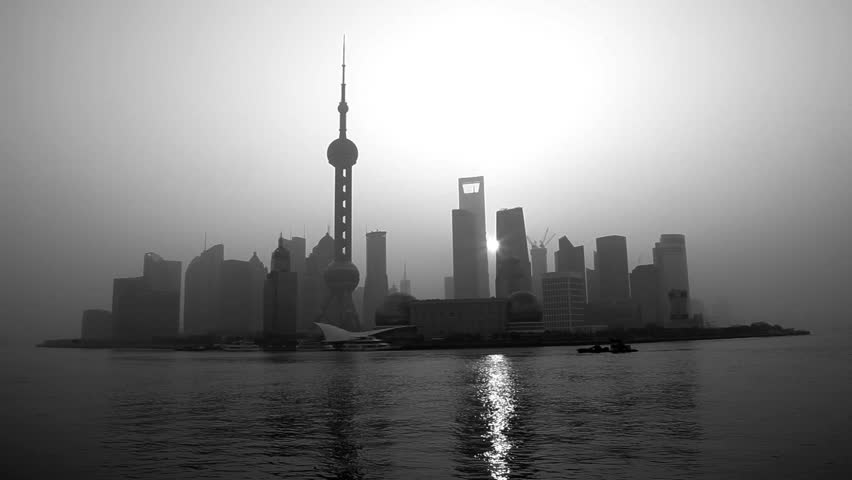 China - January 2012: Monochrome panorama of sunrise behind modern Shanghai skyline with Oriental Pearl Tower, Huangpu River, Pudong district, Shanghai, China in January, 2012