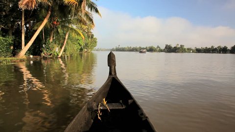 POV river canoe of water traffic on the Kerala river backwaters, Alleppey, Kerala, India