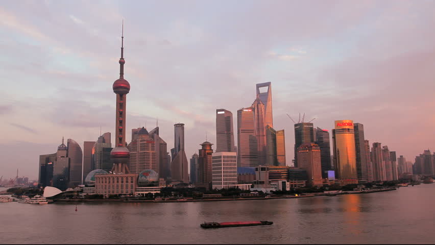 China - January 2012: Shanghai city skyline at dusk with the Oriental Pearl Tower, Huangpu River, Pudong district in Shanghai, China in January, 2012
