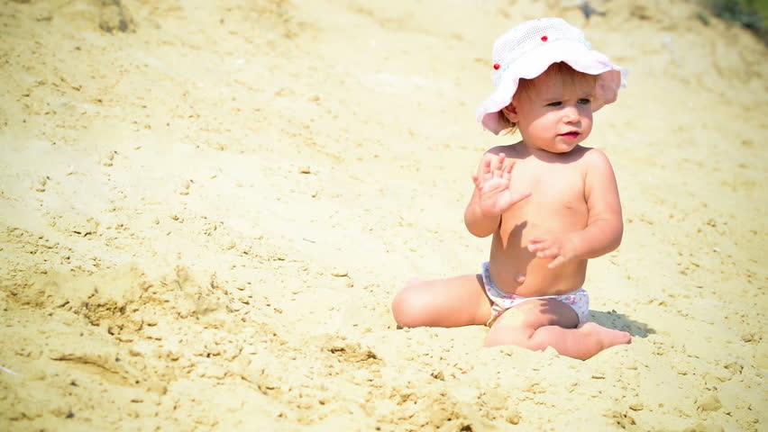 Baby playing in the sand 