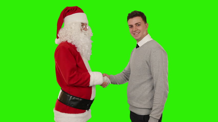 Santa Claus and Young Businessman shaking hands, Green Screen