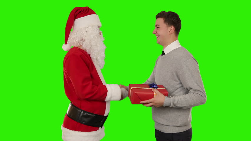 Young Businessman receiving a present from Santa Claus, shaking hands, Green