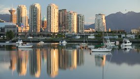 Vancouver Towers Sunrise Reflection. An early morning view of downtown Vancouver's skyline and the Coast Mountains reflected in the still waters of False Creek. British Columbia, Canada.
 - Powered by Shutterstock - Get 15% off with code: PIKWIZARD15