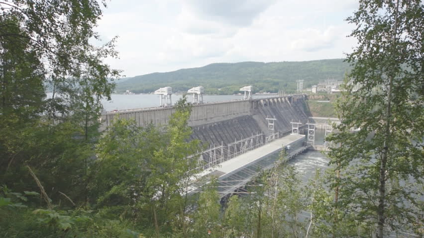 Krasnoyarsk hydroelectric power station dam 06. View of the Krasnoyarsk Dam from the right bank of the Siberian river Yenisei, summer cloudy day. Town of Divnogorsk, Siberia, Russia. August 27, 2013.