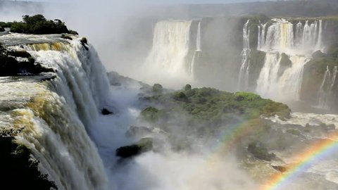 Powerful water current over Iguacu Falls creates a beautiful rainbow at Foz Do Iguacu, Brazil