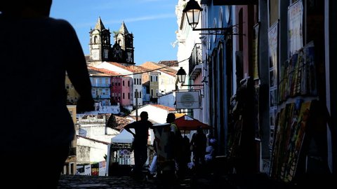 Brazil - January 2012: Street view of tourists walking up a cobblestone street in the historic old town of Pelourinho, Salvador, Brazil in January, 2012