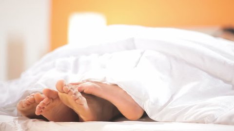 Cute Couple Playing Footsie Bed Close Stock Footage Video (100% Royalty