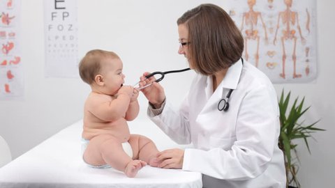 Pediatrician with child in doctor's office 