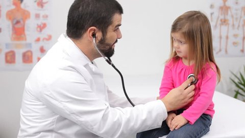 Pediatrician with child in doctor's office 