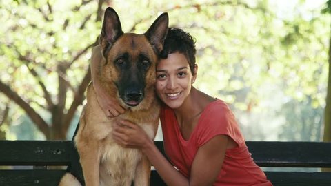 15of15 Young people and pet, portrait of happy hispanic girl at work as dog sitter with alsatian dog in park, smiling and looking at camera