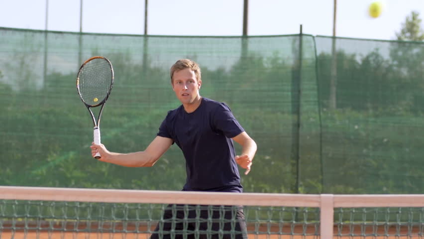 Slow Motion Shot Of A Professional Tennis Player Hitting Tennis Ball With Tennis