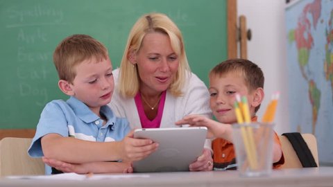 Teacher at school uses digital tablet in classroom Stock Video