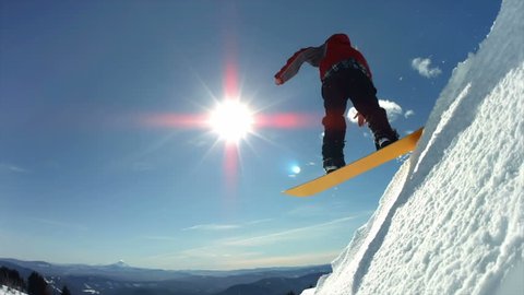 Snowboarder jumps off snow cliff, slow motion Stock Video