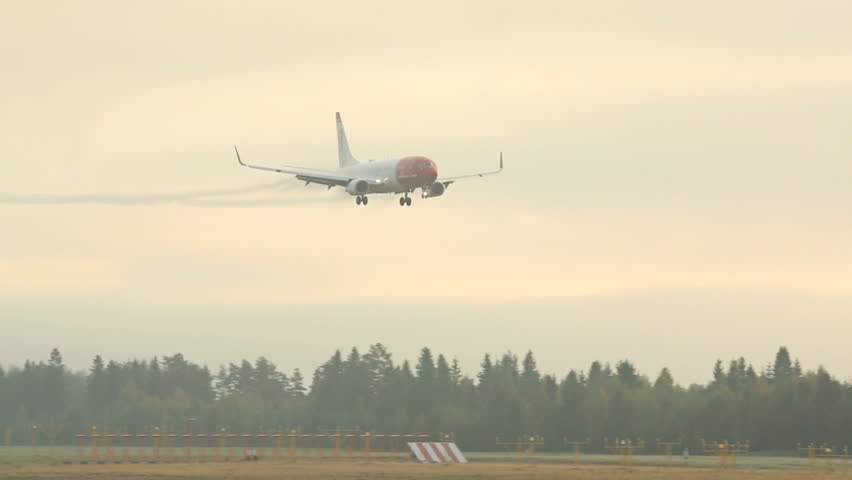 OSLO AIRPORT NORWAY FRIDAY 13 SEPTEMBER 2013: Airplane landing in severe fog