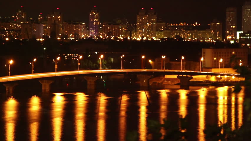 Night sleeping city cars drive on bridge yellow light reflection