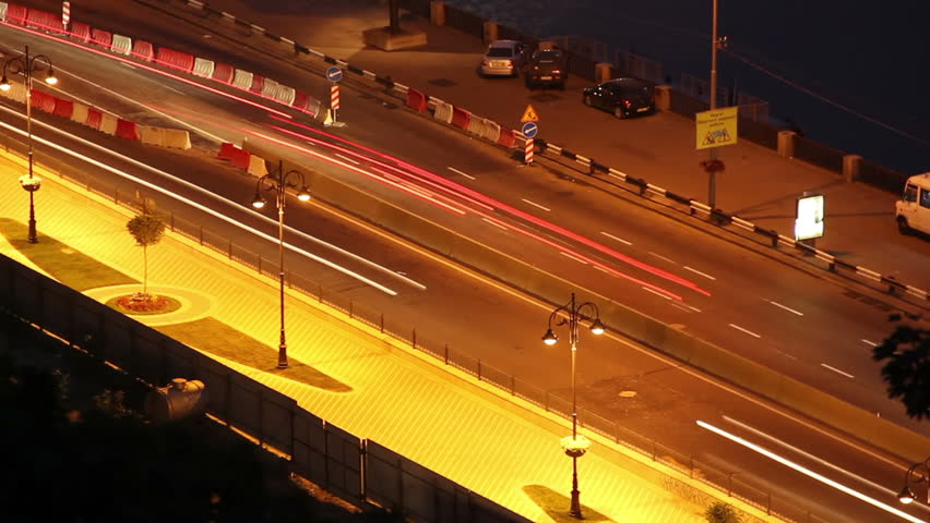 Night city road time lapse cars move leaving long traces