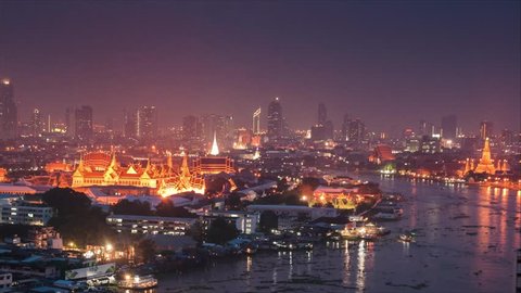 Timelapse of sunset and dusk at Grand palace in Bangkok, Thailand along the Chaopraya river