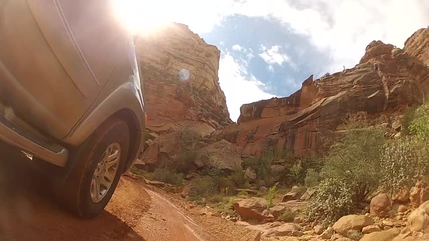 An SUV driving through Capitol Reef National Park exterior shot