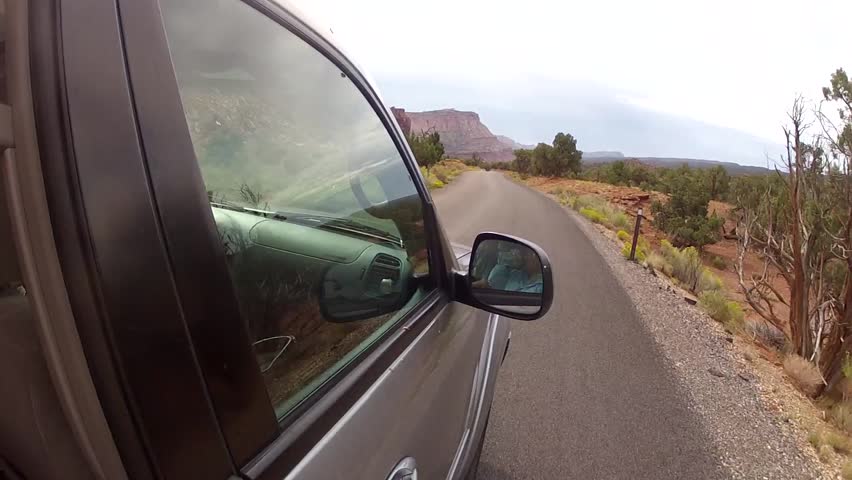An SUV driving through Capitol Reef National Park exterior shot