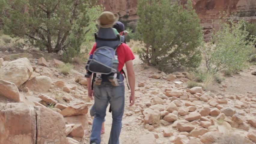 A family hiking through the desert of Capitol Reef National Park