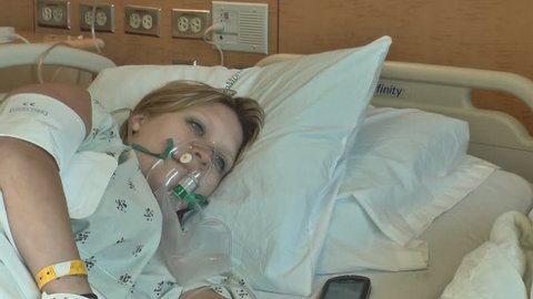 woman sick in hospital bed
