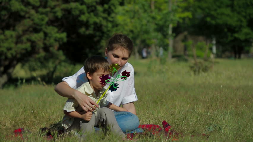 Little boy is playing with his mum in the park.