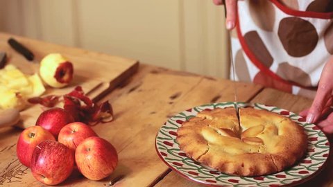 Close up on woman's hands cutting a pie in stylish kitchen Stock Video