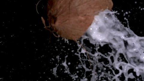 Coconut breaking open in slow motion