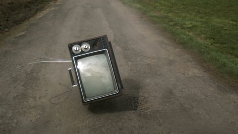 Televison bouncing on country road