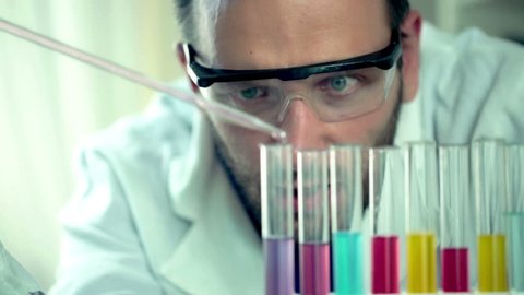 Male scientist doing lab test with chemicals
