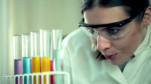Female scientist examine test tubes in laboratory
