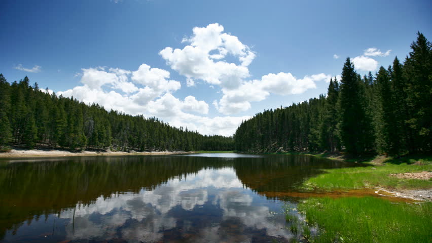 Time lapse shot of clouds reflecting on lake