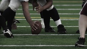 Low angle foot shot of football players running a play
