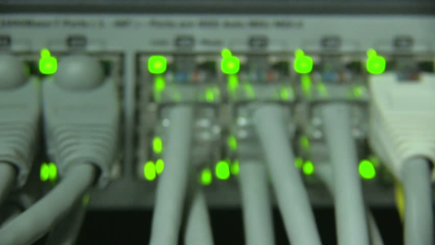 Cables and connections on network server. Blurred green lights