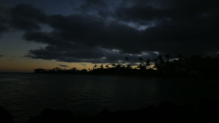 Hawaii Sunrise Sunset Over Ocean and Palm Trees on Oahu island, near Honolulu, USA.
