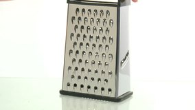 An unrecognizable person grating cheese