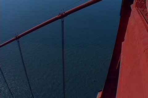 High angle shot from the top of the Golden Gate Bridge's South Tower, pans to San Francisco, with traffic below.