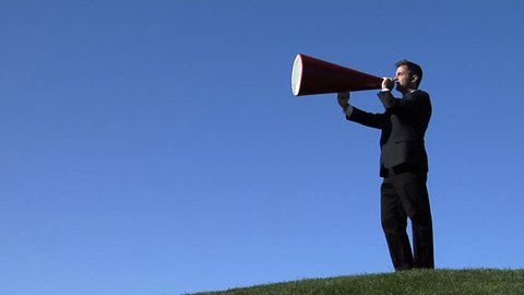Businessman shouting through a megaphone