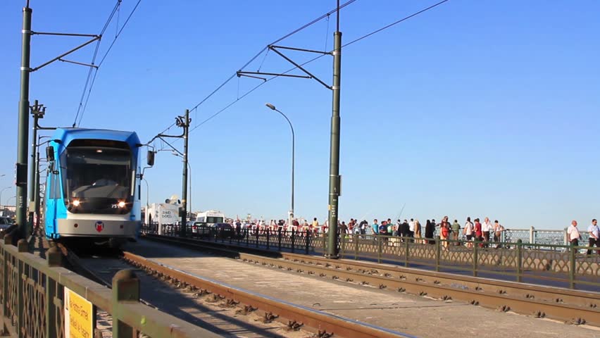 ISTANBUL - JULY 22: Modern tram passes Galata Bridge on July 22, 2011 in