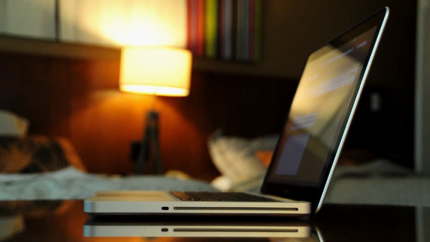 A businessman uses his laptop in his hotel room.