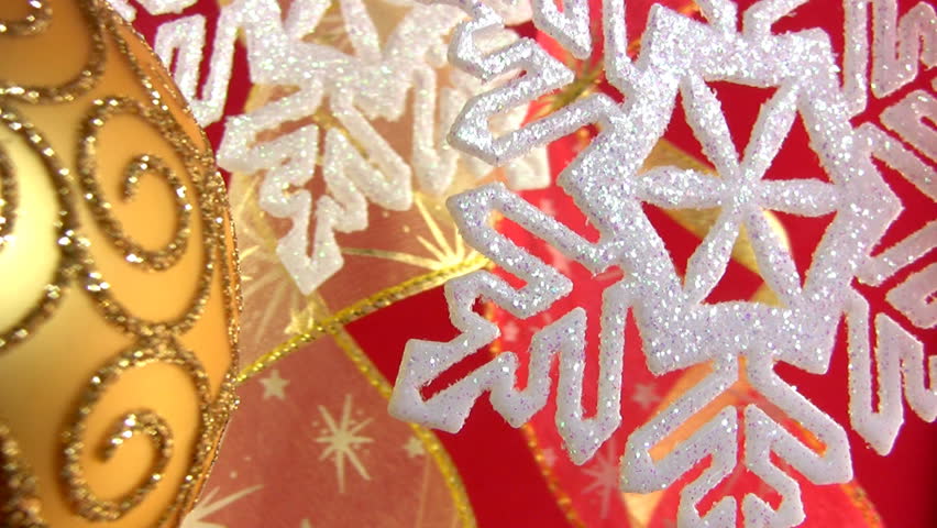 White shiny snowflake flickering on the festive backdrop of decorative ribbons
