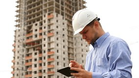 construction engineer with the tablet. take videos construction.