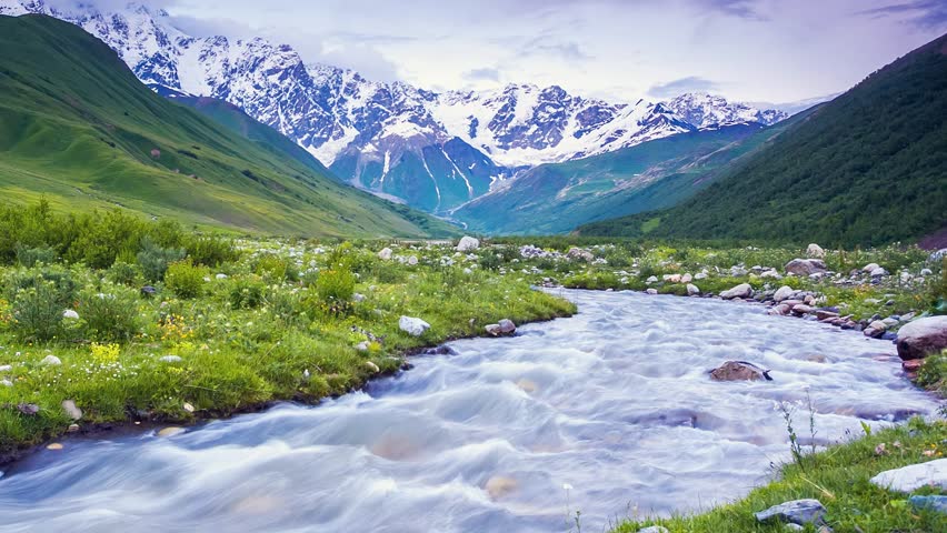Time lapse clip. River in mountain valley at the foot of  Mt. Shkhara. Upper