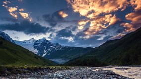 Time lapse clip. River in mountain valley at the foot of Tetnuldi glacier. Upper Svaneti, Georgia, Europe. Caucasus mountains. Beauty world. HD video (High Definition).