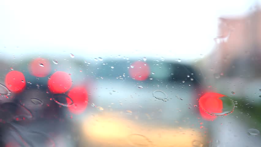 Light Art of Rain drops on the glass when Car driving