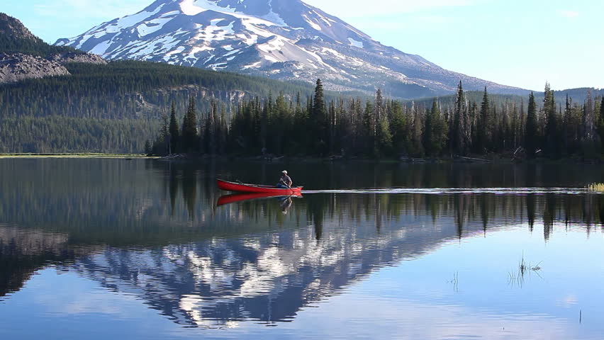 Man rowing canoe on lake