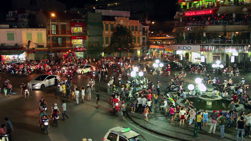 HANOI - 18 SEPTEMBER: View of people walking between traffic in the  Hoan Kiem
