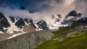 Time lapse clip. Alpine meadows with dramatic sky at the foot of  Mt. Ushba. Upper Svaneti, Georgia, Europe. Caucasus mountains. Beauty world. HD video (High Definition)